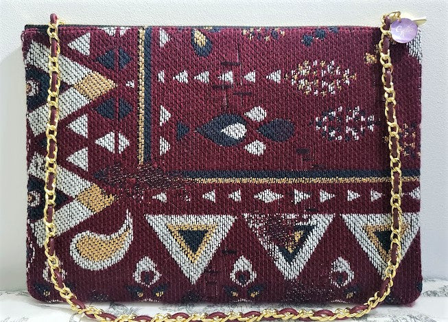 Sac pochette chaîne "Bouquet multicolore de gerberas, près du tapis."